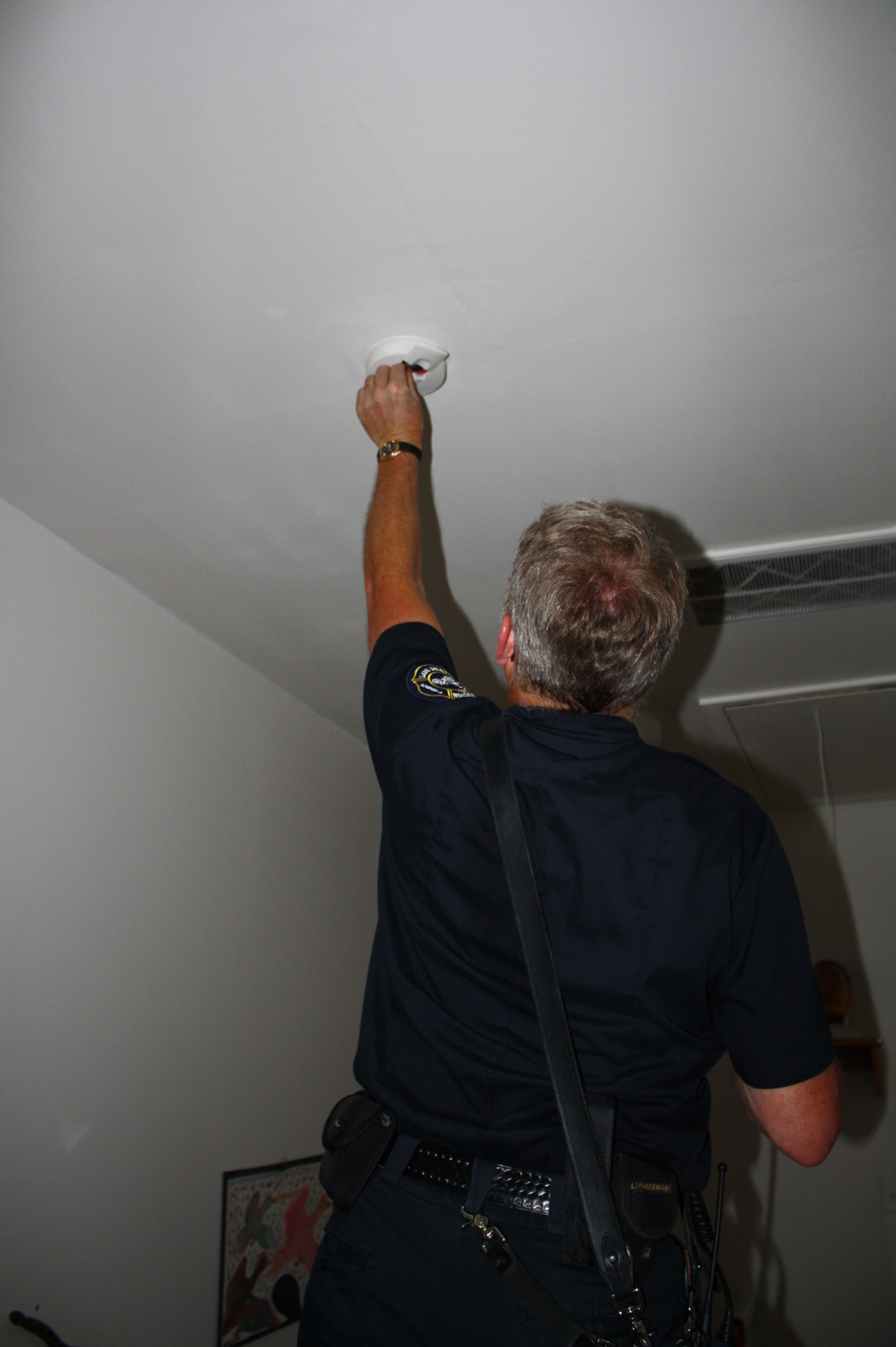 Firefighter Checking Smoke Alarm Batteries