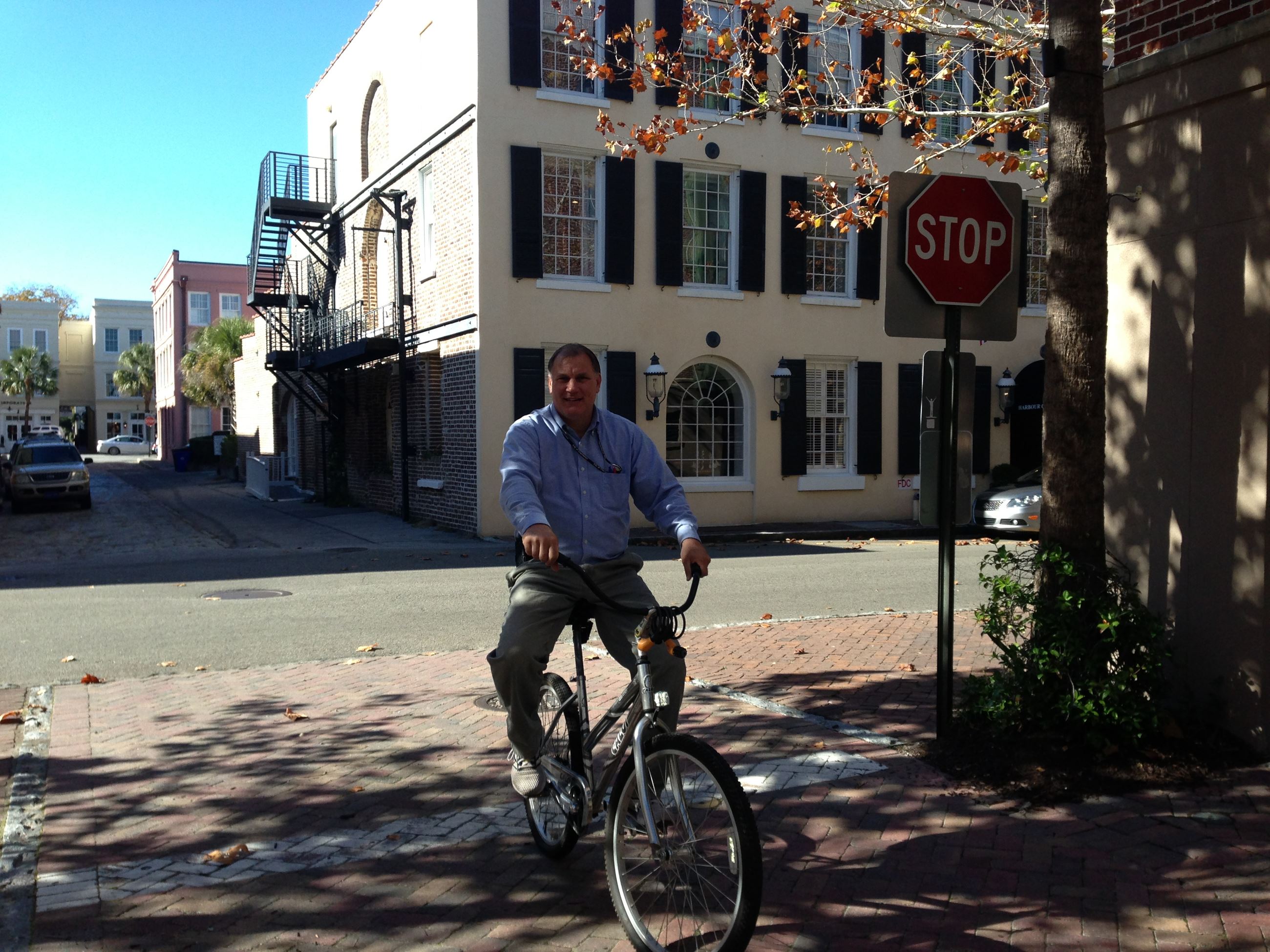 Eric riding a bike in downtown Charleston Opens in new window